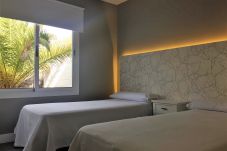 Dormitorio con 2 camas individuales y luces led en el cabecero