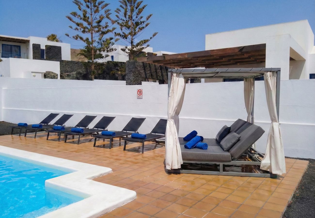 Balinese bed and loungers by the pool