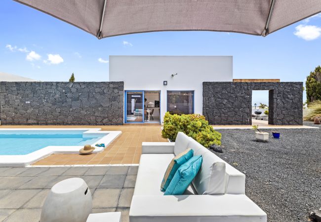 White outdoor sofas with blue cushions