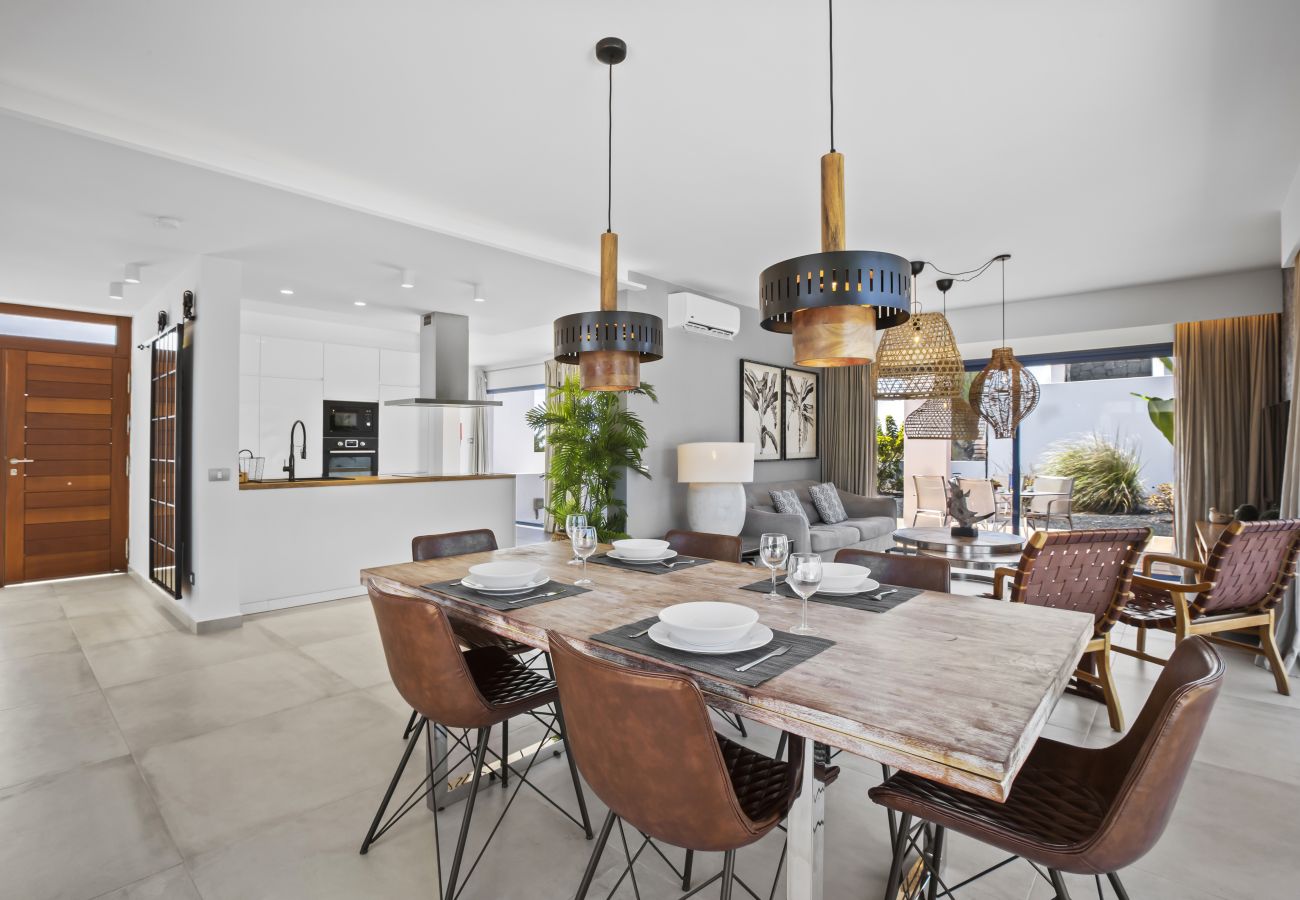 Dining table with brown chairs and black lamps