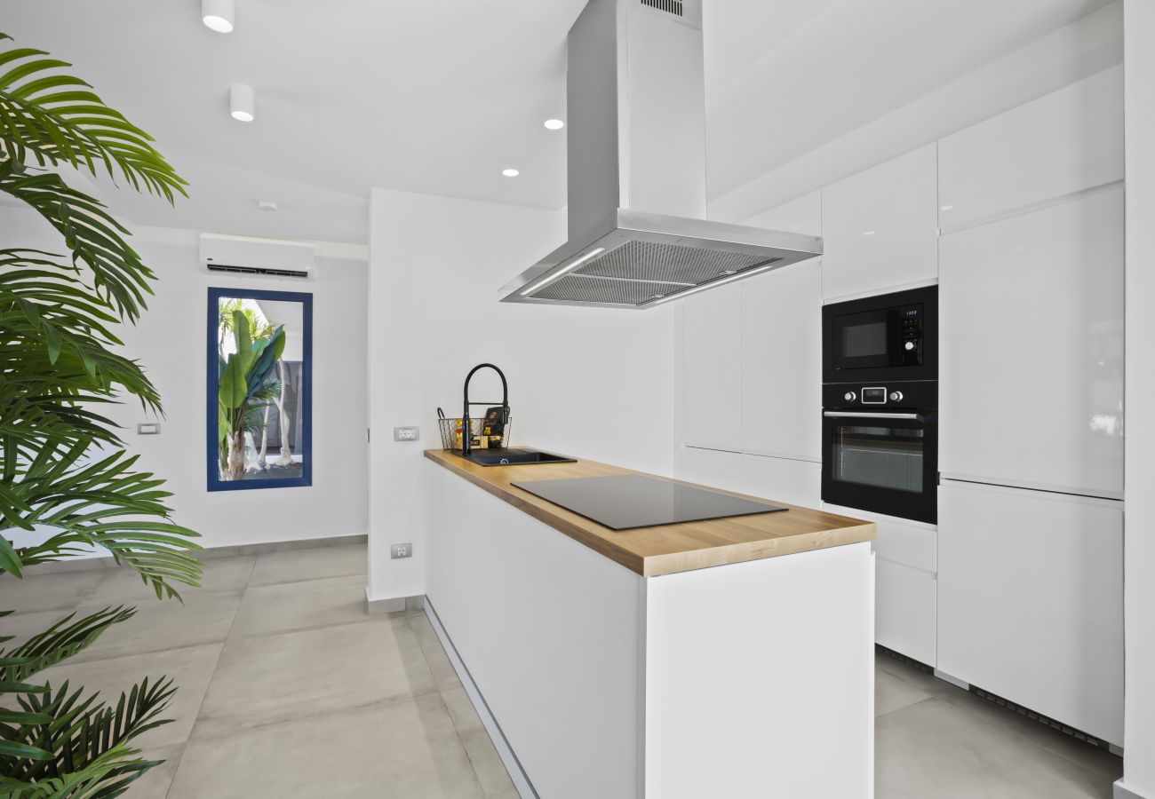 White kitchen with island and wood details