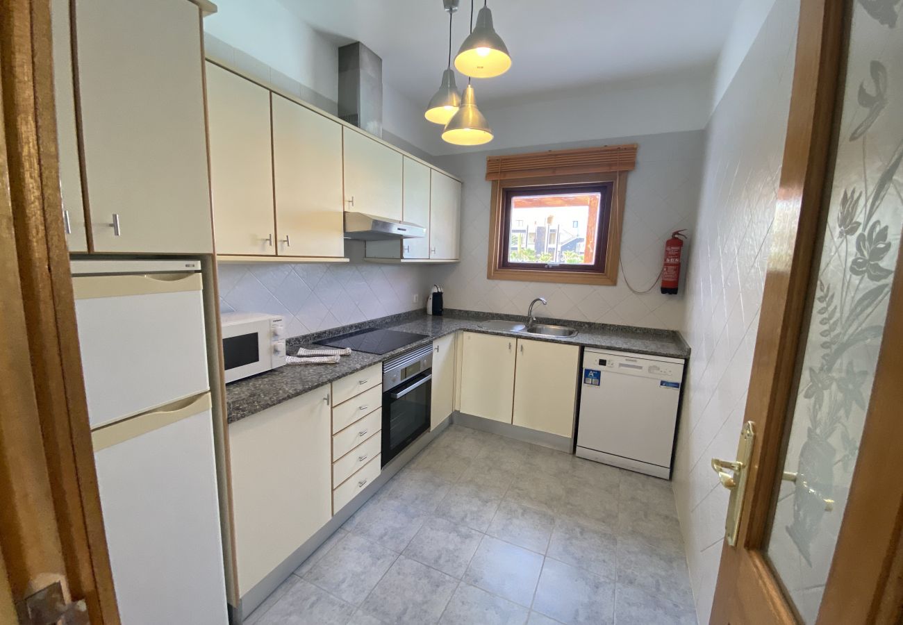 Full cream-colored kitchen with appliances at Villa Capri