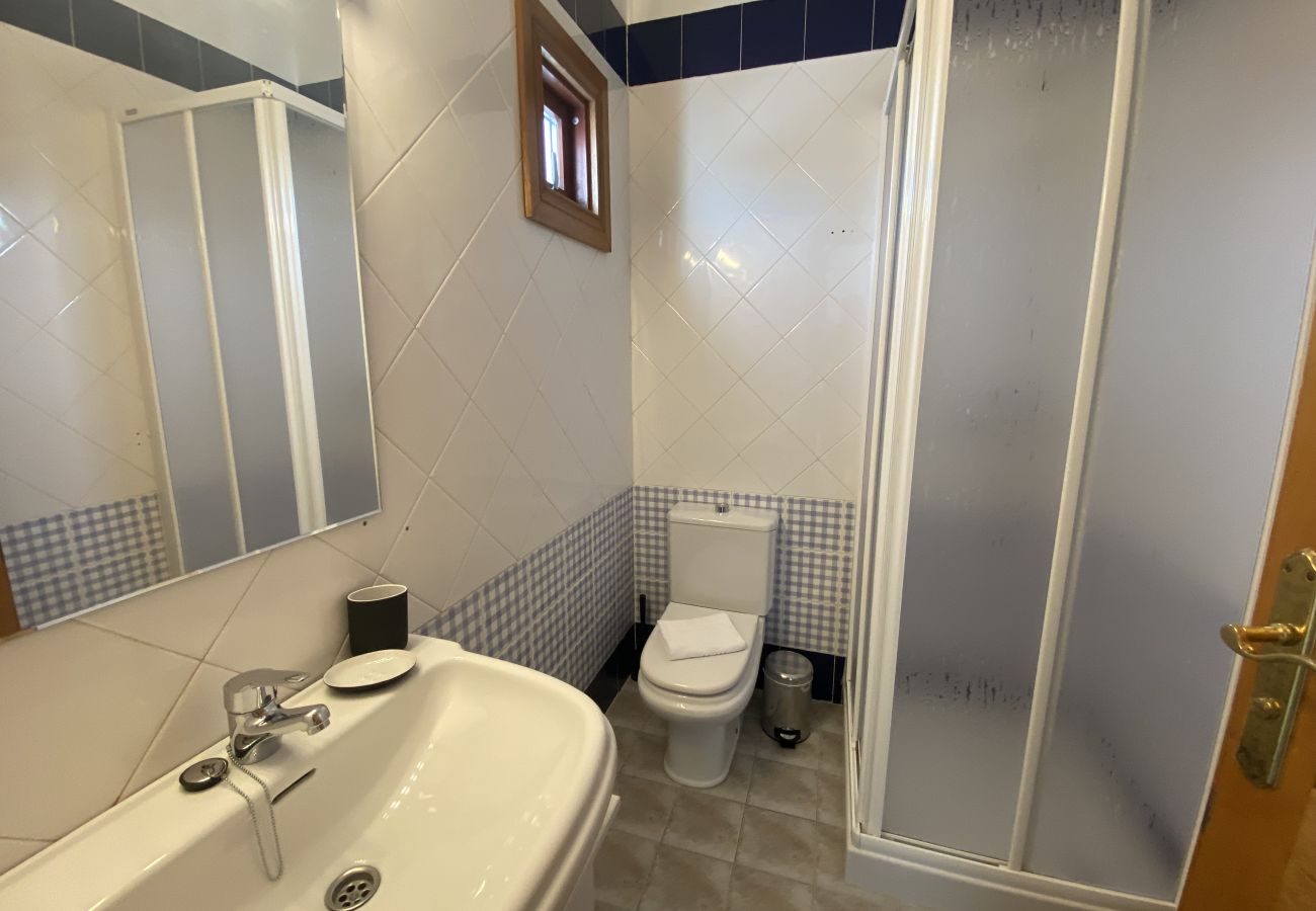 Sink on black cabinet and large mirror at Villa Capri