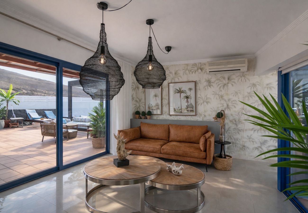 Spacious and bright living room with comfortable sofa in holiday villa