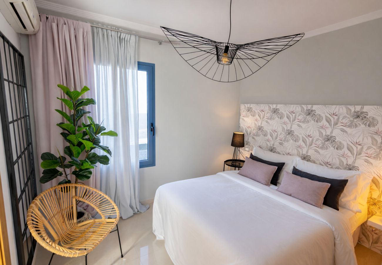 Master bedroom with double bed in modern holiday villa