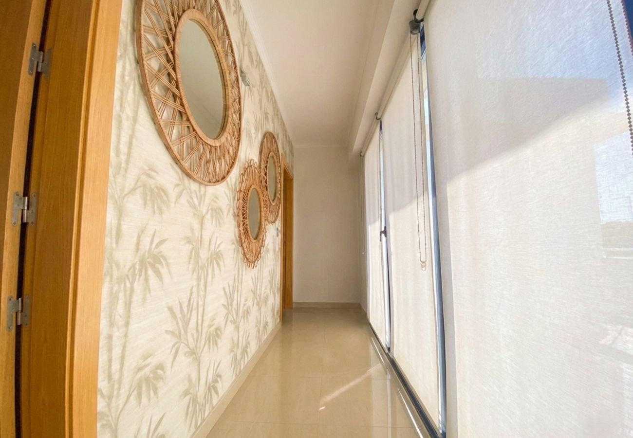 Interior hallway with round wicker mirrors