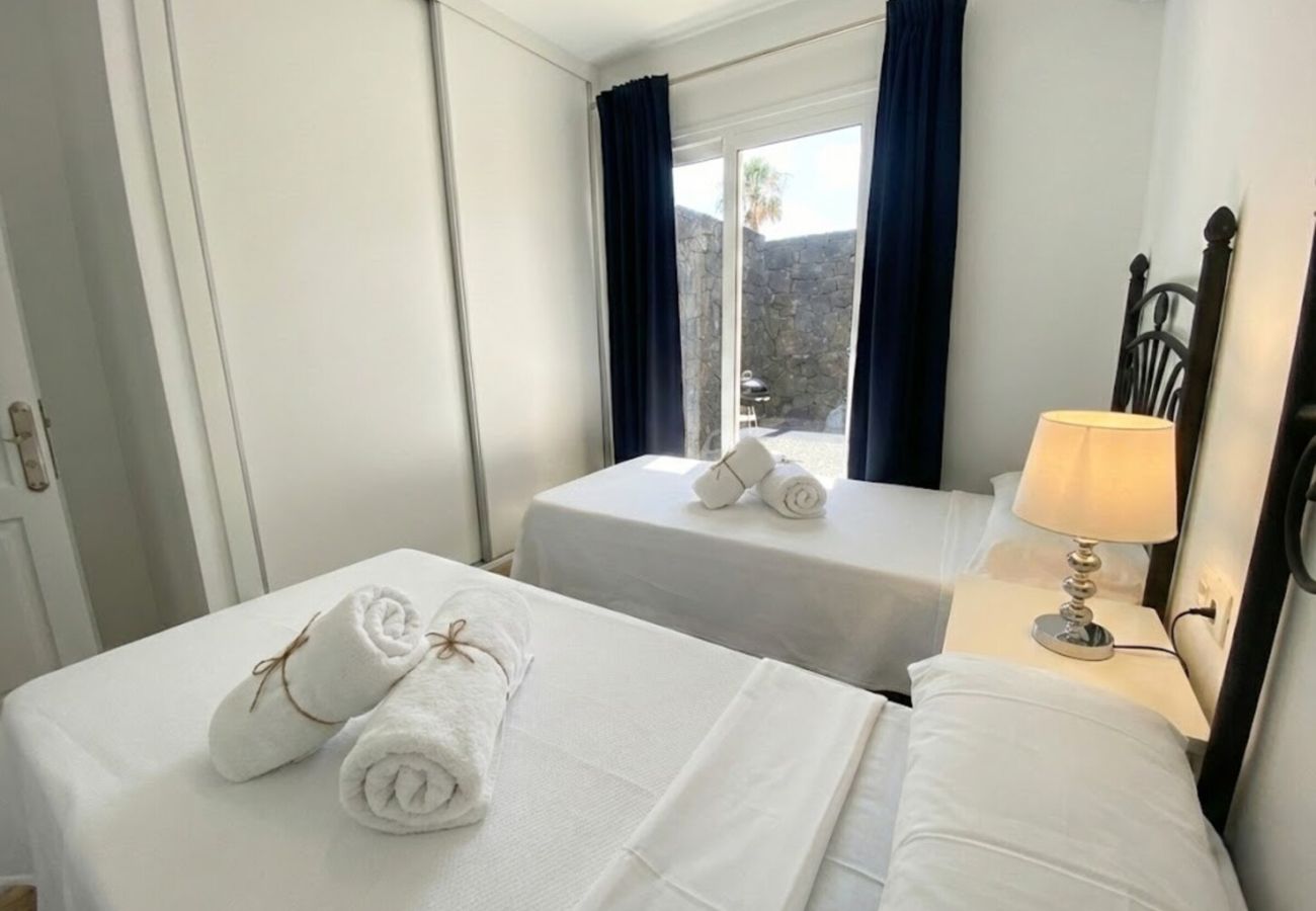 Single beds next to window with curtains