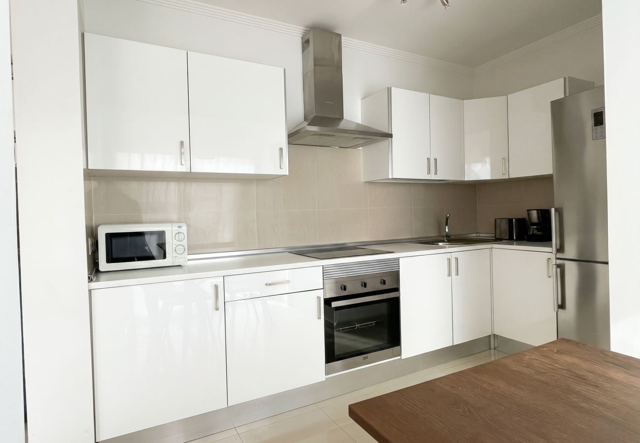 Fully equipped modern white kitchen in a villa.