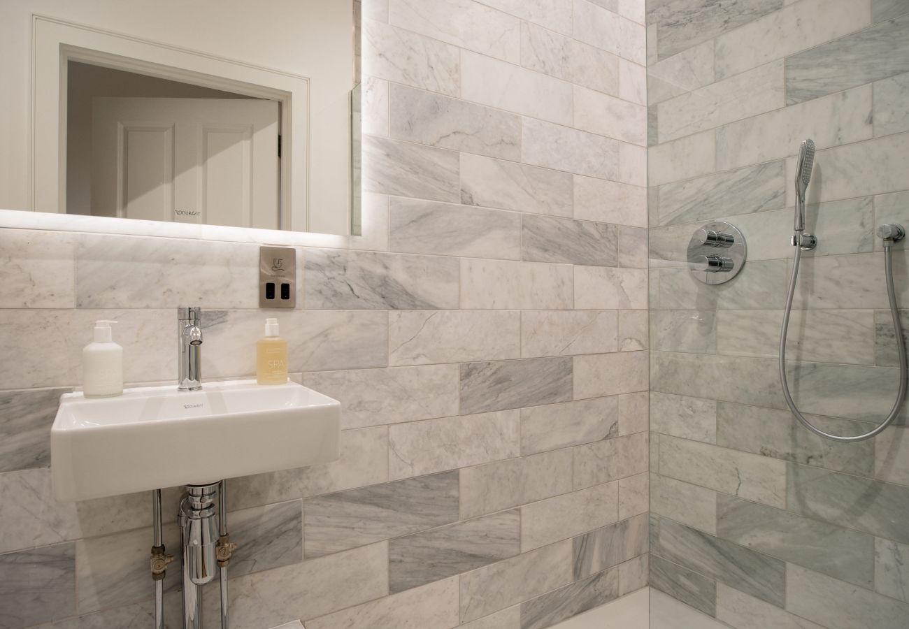 Marble-tiled bathroom with premium ceramics in the Exeter Cathedral View apartment.