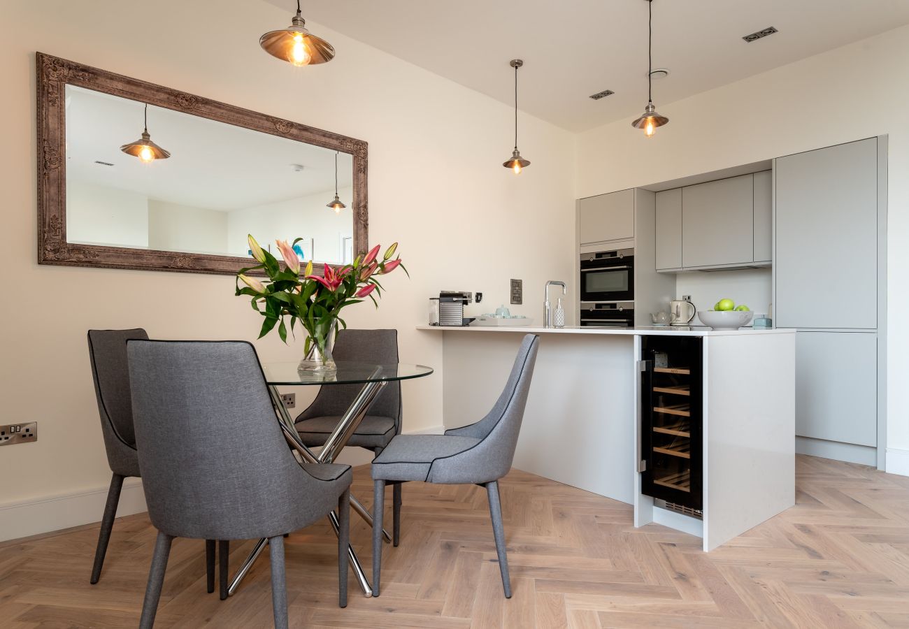 Open-plan living and dining area in Exeter apartment with cathedral views.
