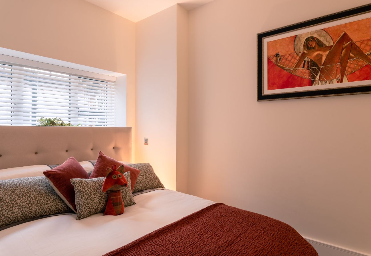 Comfortable bedroom in Exeter Cathedral Green apartment, with fitted wardrobes and neutral tones.
