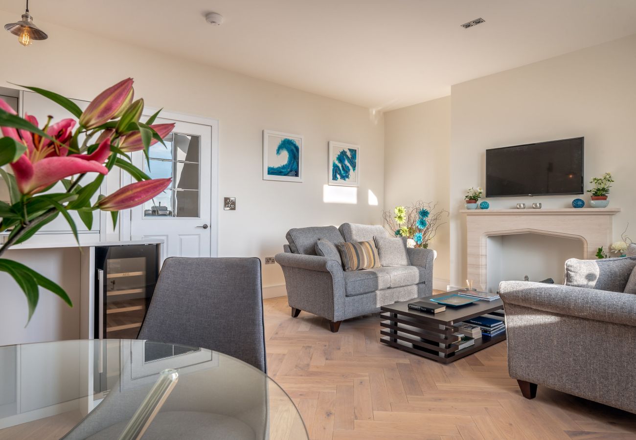 Open-plan living and dining area in Exeter apartment with cathedral views.