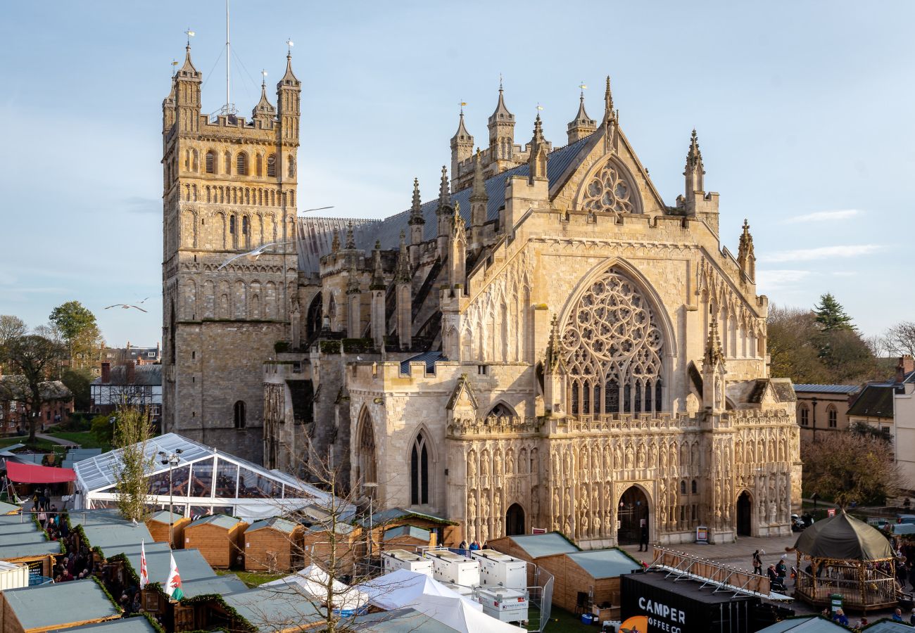 Exeter Cathedral lit up at night, seen from a Cathedral Green apartment.