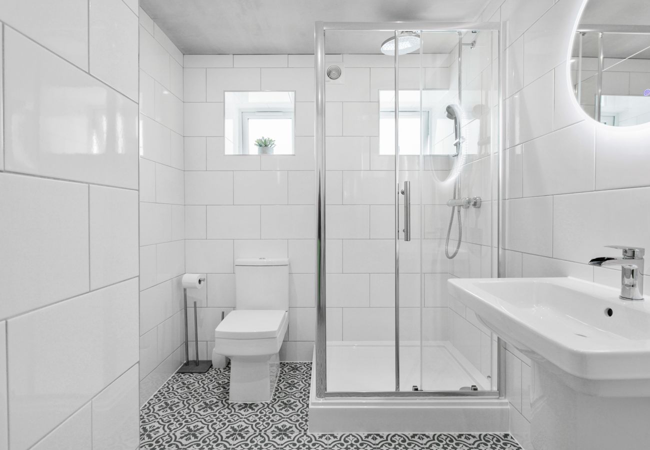 Bathroom in Coombe Bank apartment with double shower cubicle and modern tile design