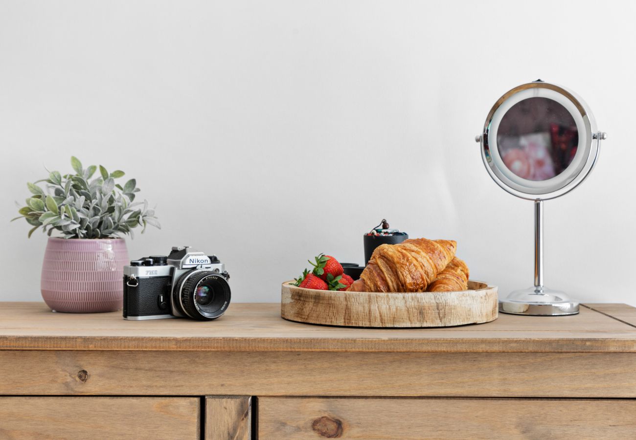 Master bedroom with king bed and soft sea-tone décor at Coombe Bank, Teignmouth