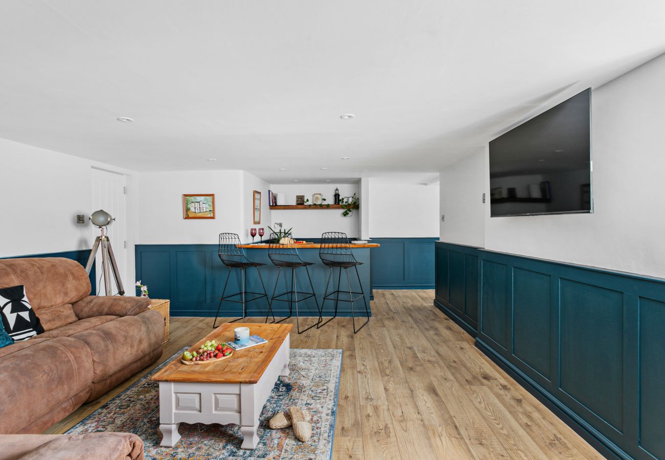 Living room in Coombe Bank apartment, Teignmouth, with dry bar and smart TV