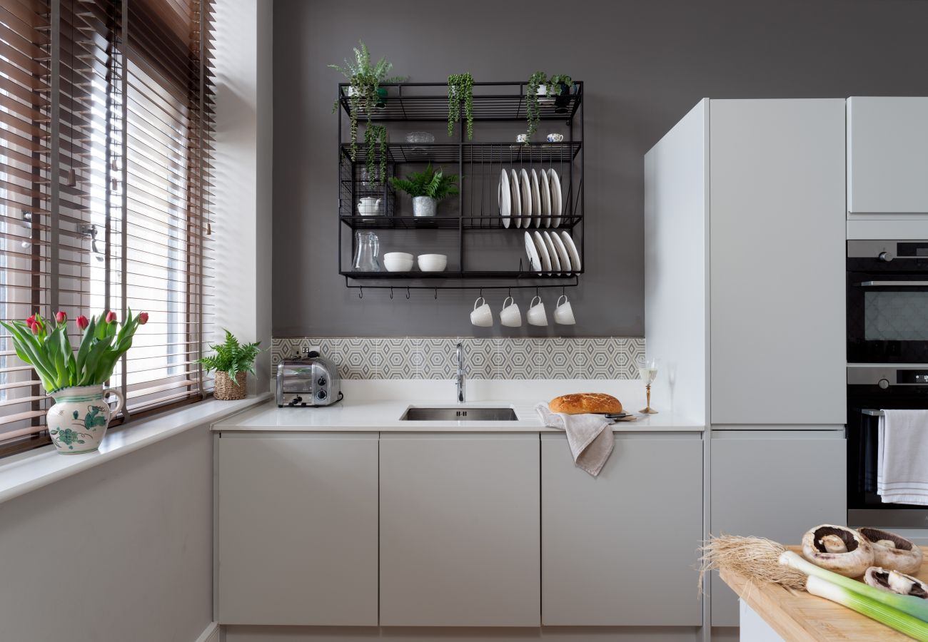French grey kitchen with breakfast bar in apartment