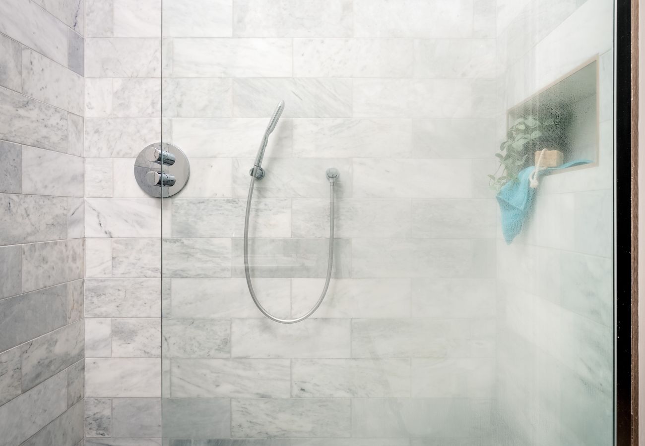 Marble shower room with premium ceramics in apartment