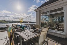 Private garden with entertainment deck, fire pit, and panoramic views of the Teign Estuary in a South Devon holiday home.
