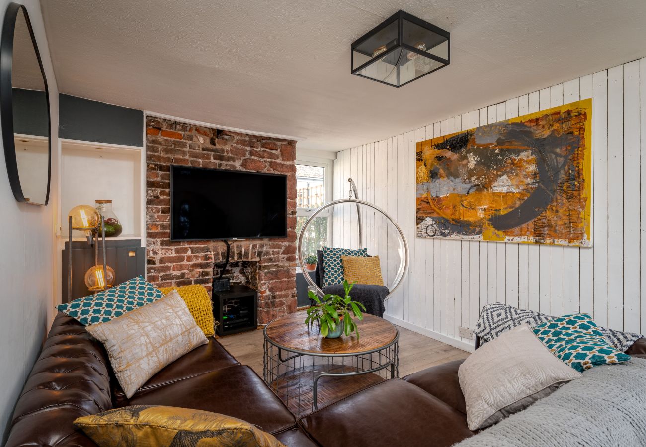 Living room in Crab Shack apartment with hanging bubble chair and wood-burning stove
