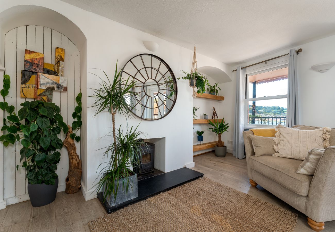 Dining area in The Crab Shack apartment with doors leading to balcony and sea view