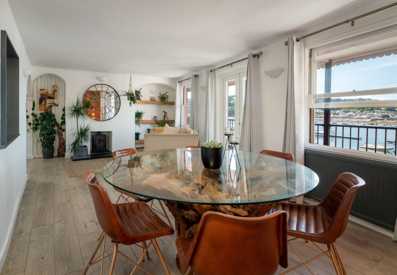 Dining area in The Crab Shack apartment with doors leading to balcony and sea view