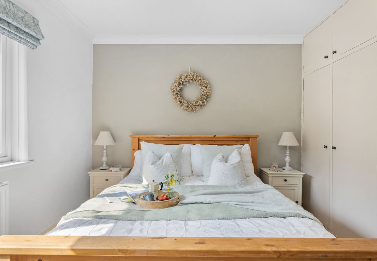Master bedroom with king bed and built-in wardrobe in Bramblewood cottage