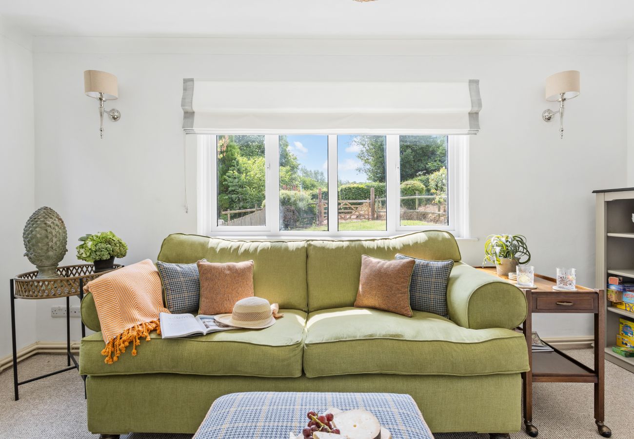 Living room in Bramblewood cottage with double-sided fireplace and wood stove