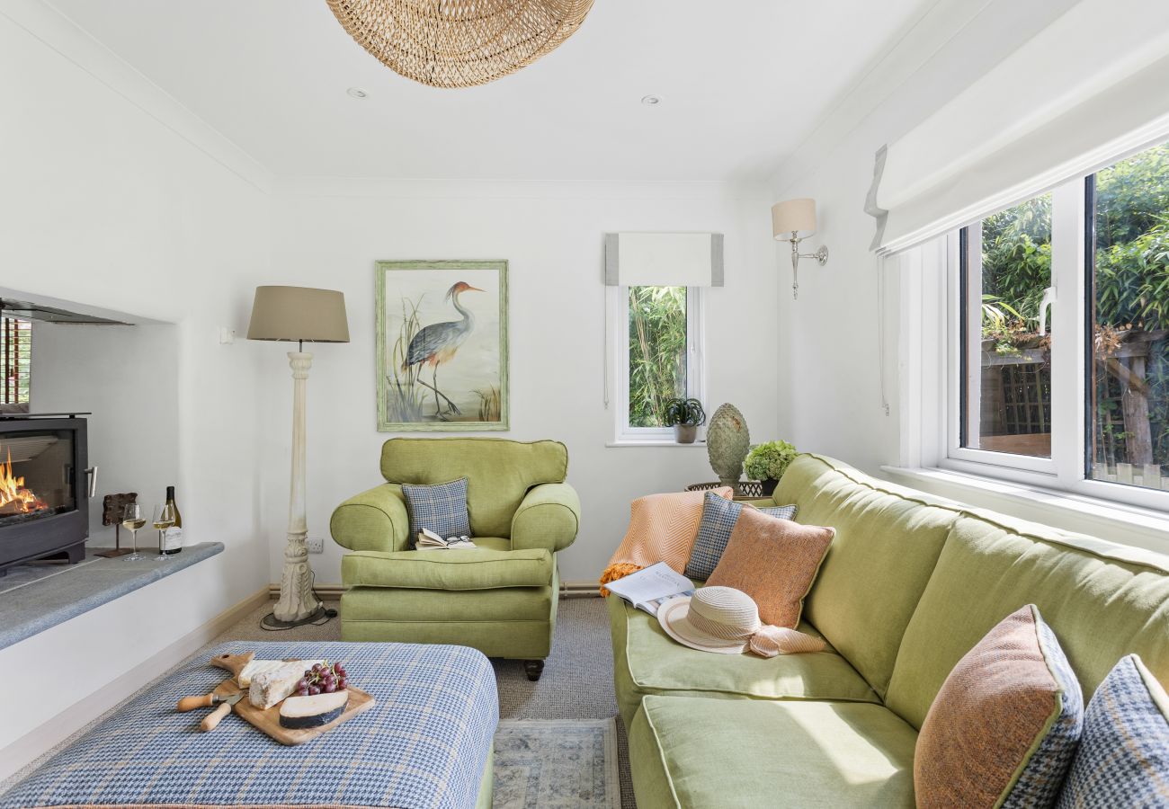 Living room in Bramblewood cottage with double-sided fireplace and wood stove